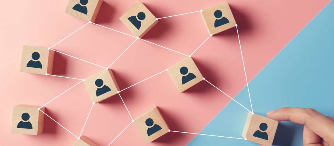 building-strong-team-wooden-blocks-with-people-icon-blue-pink-background-human-resources-management-concept